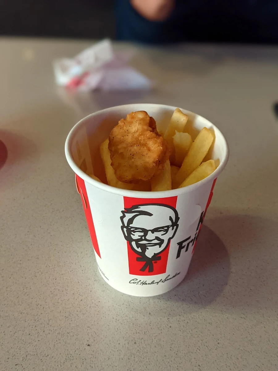 Chicken Nuggets Served on a Bed of Fried Potatoes