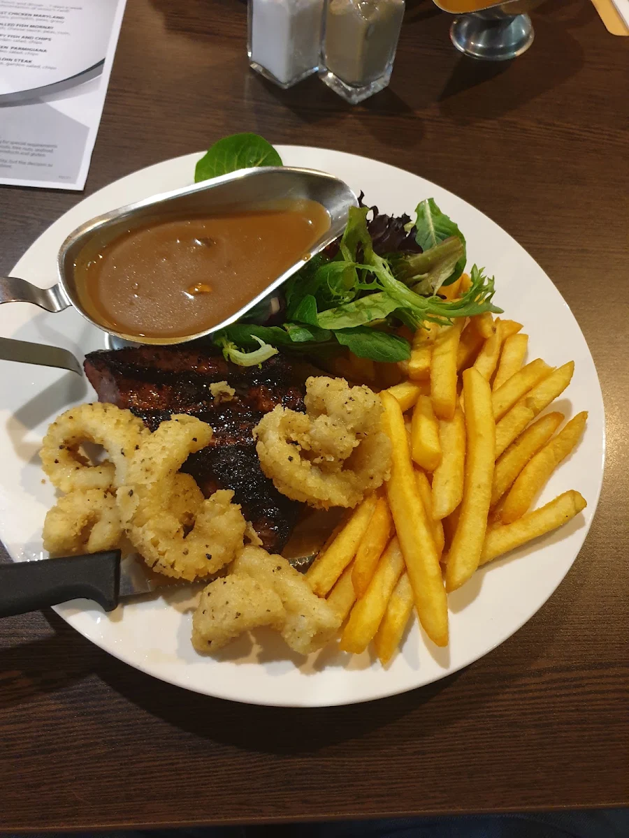 250gm Rump Steak with Salt & Pepper Calamari Covered in Mushroom Sauce Served with Chips and Salad