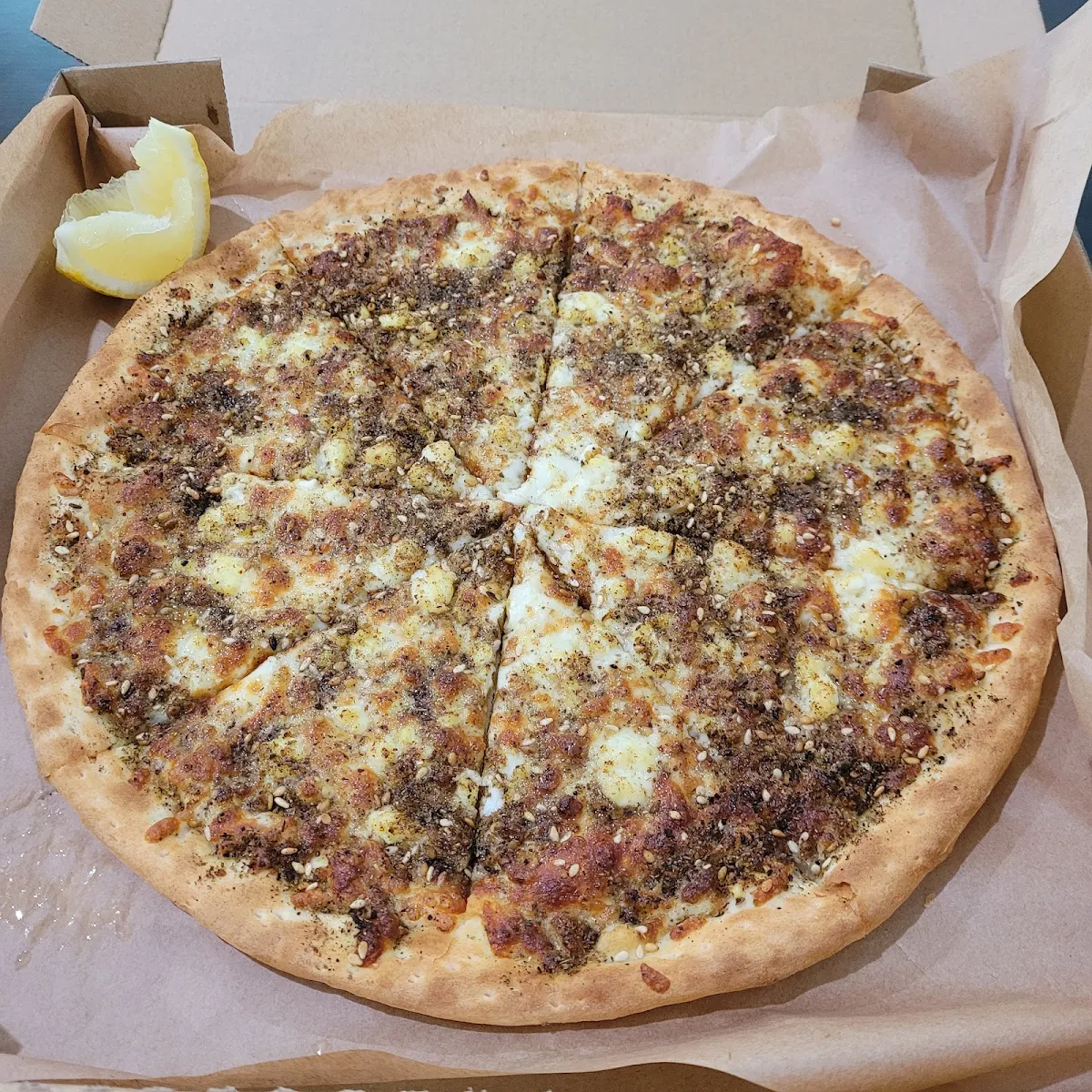 Meat and Cheese Pizza with a Dash of Chilli and Lemon