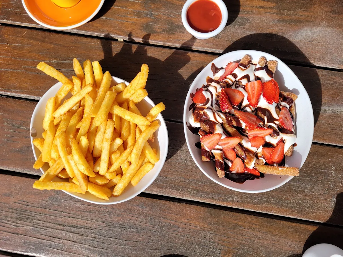 Chips on the Left Donut Chips with Chocolate Sauce and Cream with Sliced Strawberries on the Right