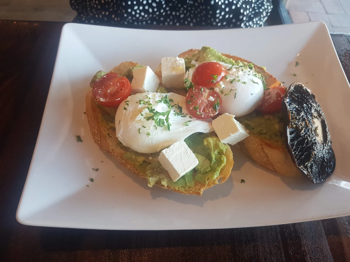 Smashed Avocado Poached Eggs and Side of Hollandaise Sauce