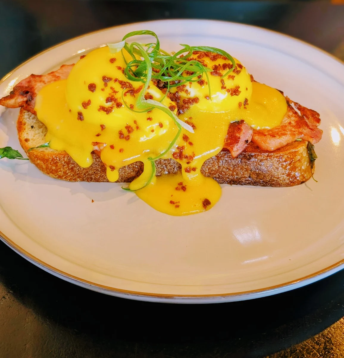 Eggs Benedict with Cardamom Hollandaise on Sourdough with Bacon Smoked Salmon Option