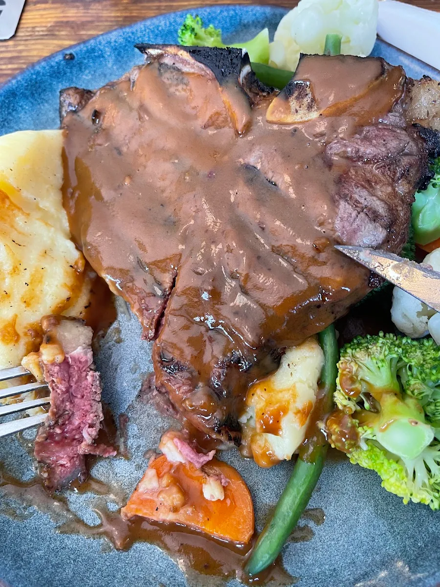 T-Bone Steak Cooked to Perfection with Mashed Potato and Steamed Vegetables
