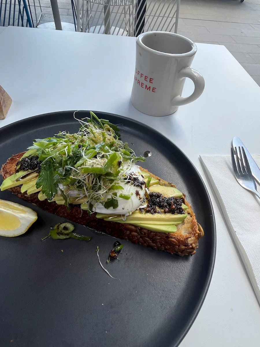 Avocado Toast with Chilli Crisp Poached Egg and Herbs
