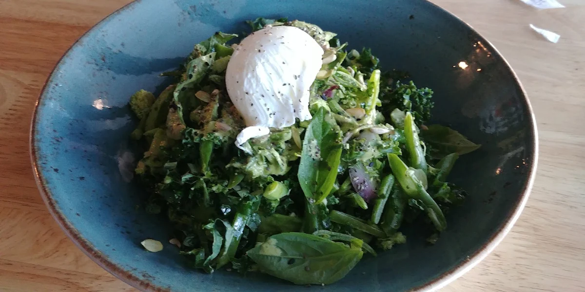 Green Bowl with Avocado Pepita Seed Hummus Goddess Dressing Poached Egg and Seeds