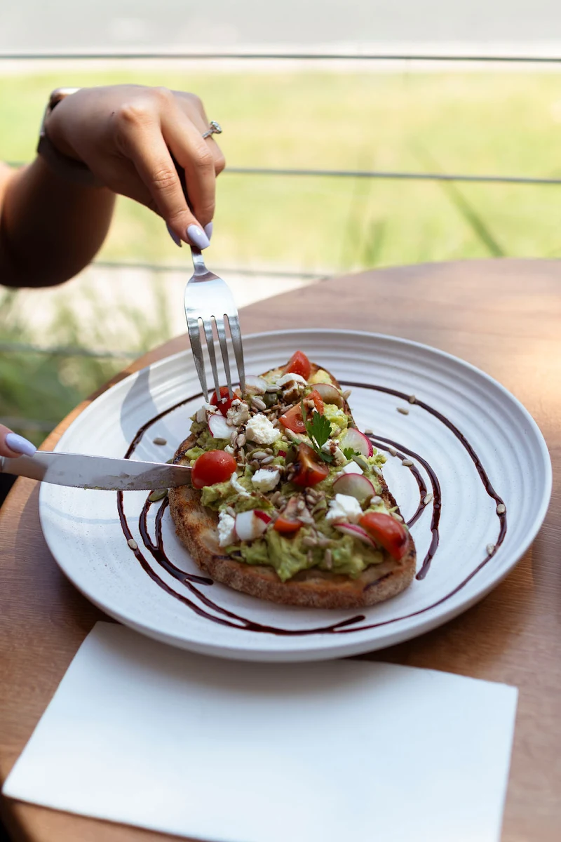 Smashed Avo GFO with Feta Cherry Tomato Radish Balsamic Glaze & Seeds on Sourdough Add Poached Egg 3