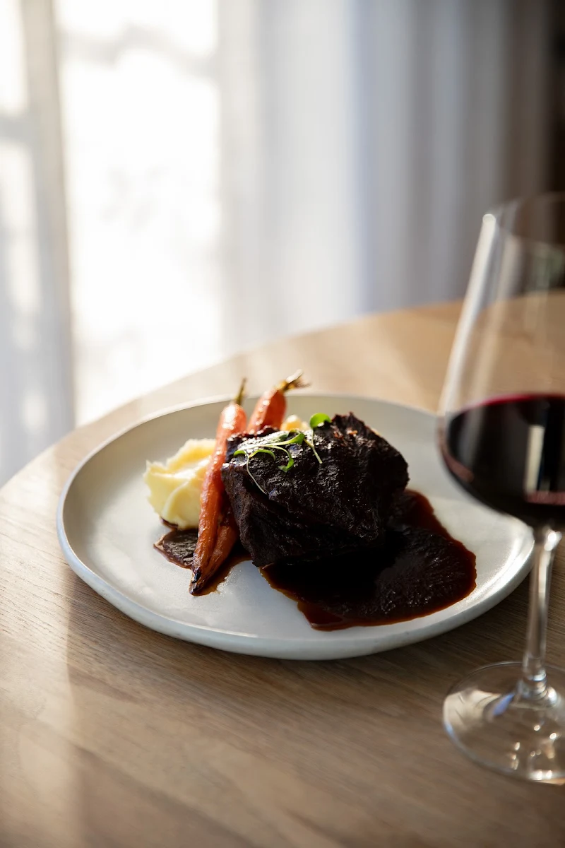 Braised Beef Cheek with Whipped Potato Dutch Carrots Red Wine Jus Gremolata, The Coast Restaurant
