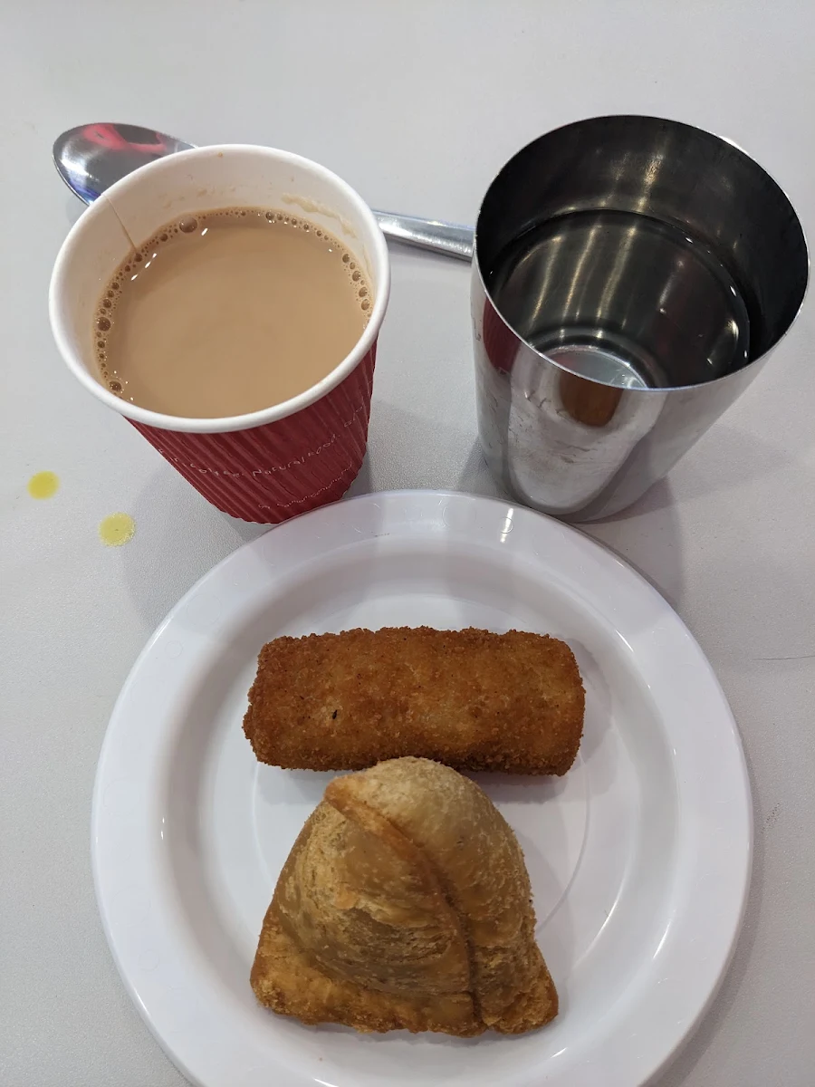 Clockwise from Top Left Masala Chai Water Veg Roll and Veg Samosa