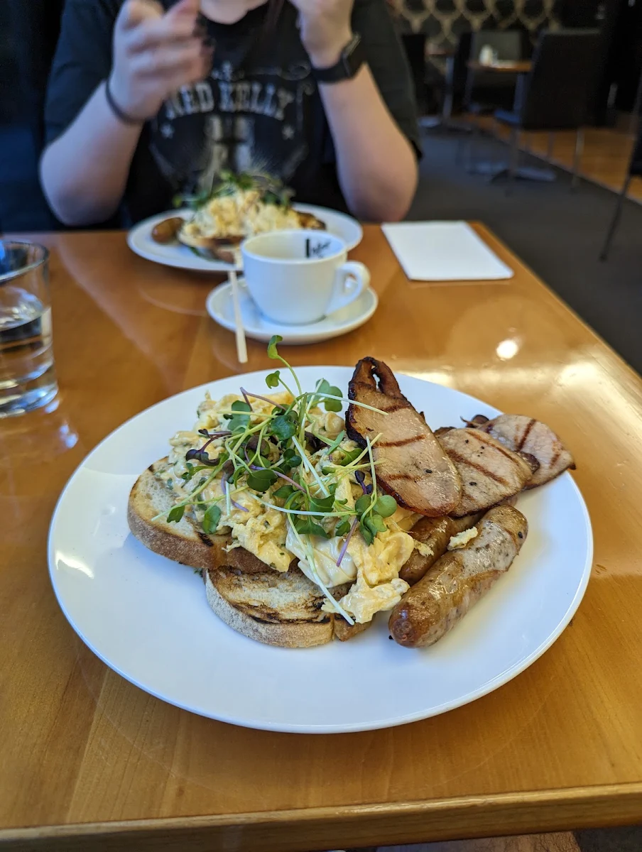 Scrambled Eggs on Toast with Bacon and Pork Sausages