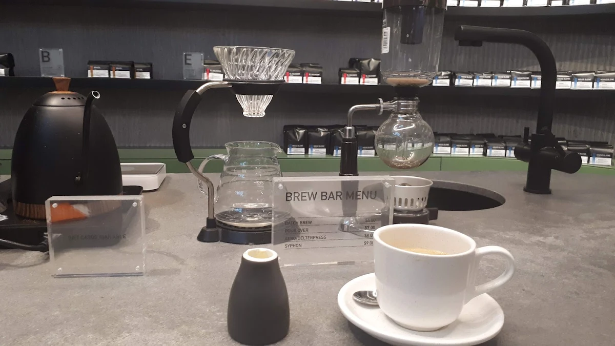 Long Black and Pouring Cream, Foster & Black Specialty Coffee Chermside