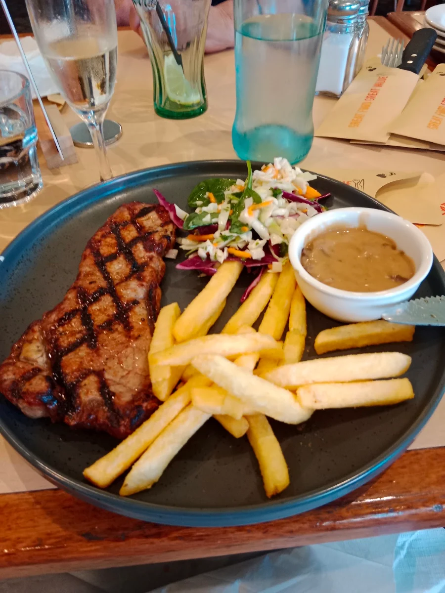 Porterhouse Steak with Mushroom Sauce on the Side with Slaw & Chips