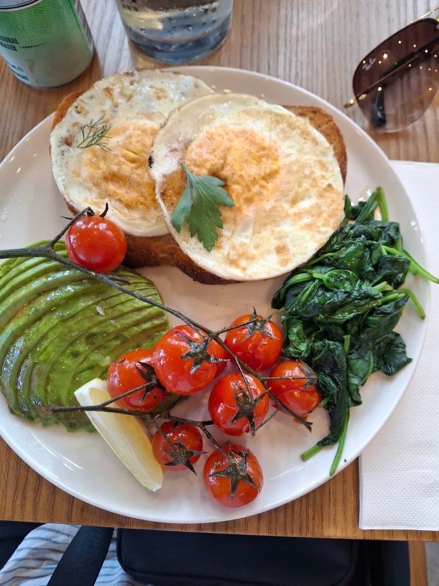 Fried Eggs with Sauteed Spinach Roasted Tomatoes and Avocado on Sourdough Bread
