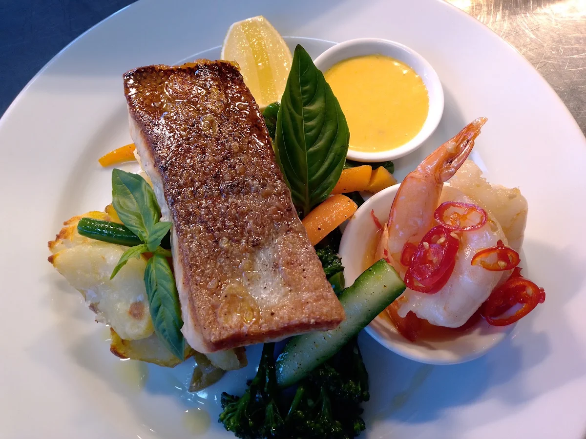 Crispy Skin Salmon Chilli Prawns Smashed Chats Seasonal Veg and Orange Hollandaise