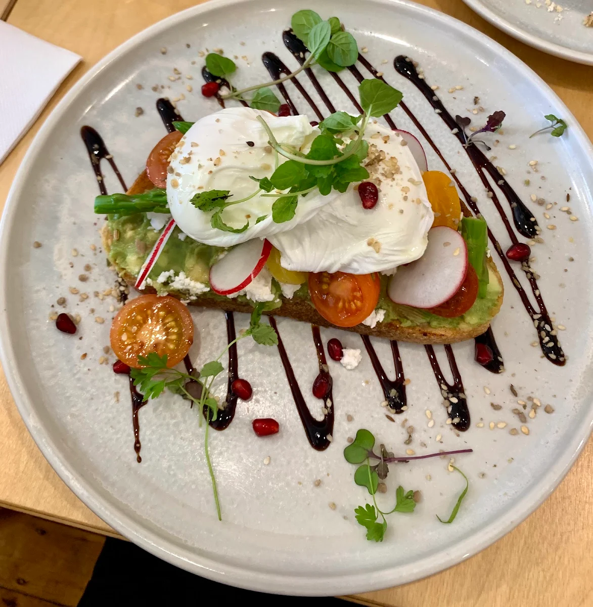Smashed Avocado with Heirloom Tomatoes Poached Eggs Feta Dukkah on Sourdough