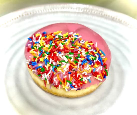 Pink sprinkle jam donut