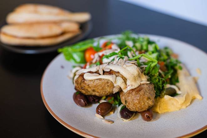 Mediterranean Plate – lamb kofta, tabouli, hummus, marinated veges, tzatziki, leaf salad/sesame seeds & pide