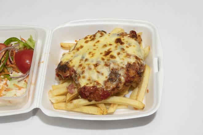 Veal Parmigiana. topped with ham, freshly made napoletana sace topped with Mozzarella Cheese.  served with chips and salad