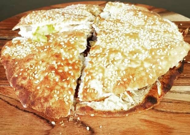 Kaak (Pizza dough rolled in sesame seeds)