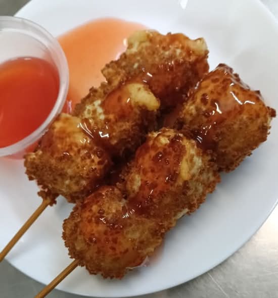 Six crispy fried pork shumai skewers.